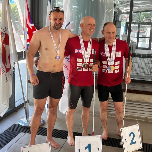 Craig Lundberg (right) receives a swimming medal in the visually impaired category. Courtesy.