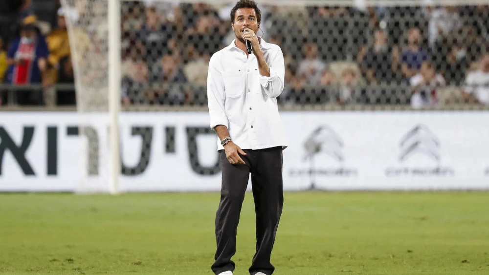 French-Israeli singer Laurent Amir Haddad, also known as Amir, performs before the start of the French Champions' Trophy final soccer match between Paris Saint-Germain and Lille at Bloomfield Stadium in Jaffa, on Aug. 1, 2021. Photo by Emmanuel Dunand/AFP via Getty Images.