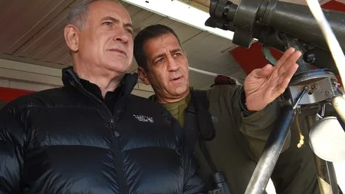 Israeli Prime Minister Benjamin Netanyahu (left) with Aviv Kochavi, head of the IDF Northern Command, during a visit to a military outpost on Mount Hermon in the Golan Heights, overlooking the Israel-Syria border, in February 2015. Credit: Effi Sharir/POOL/Flash90.