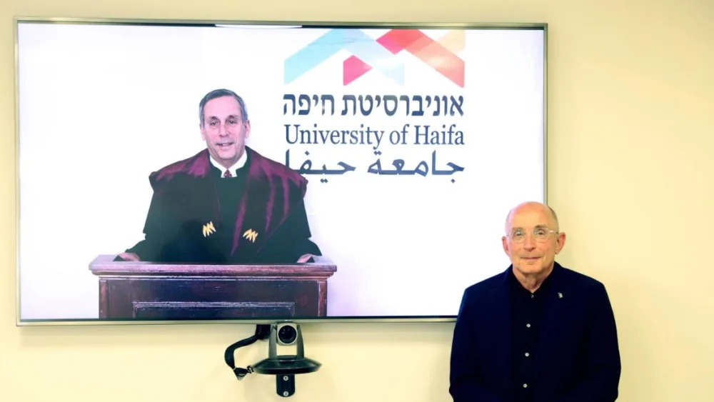 Harvard University president Lawrence Bacow receives an honorary doctorate from University of Haifa president Ron Robin, March 15, 2021. Credit: University of Haifa.