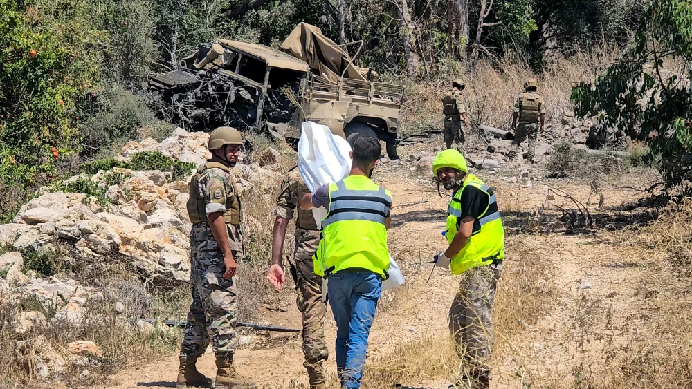 Lebanese army soldiers inspect the site of an explosion that targeted their vehicle in the Southern Lebanese area of al Mansouri near Tyre on July 18, 2026. Photo by Kawnat Haju / AFP via Getty Images.