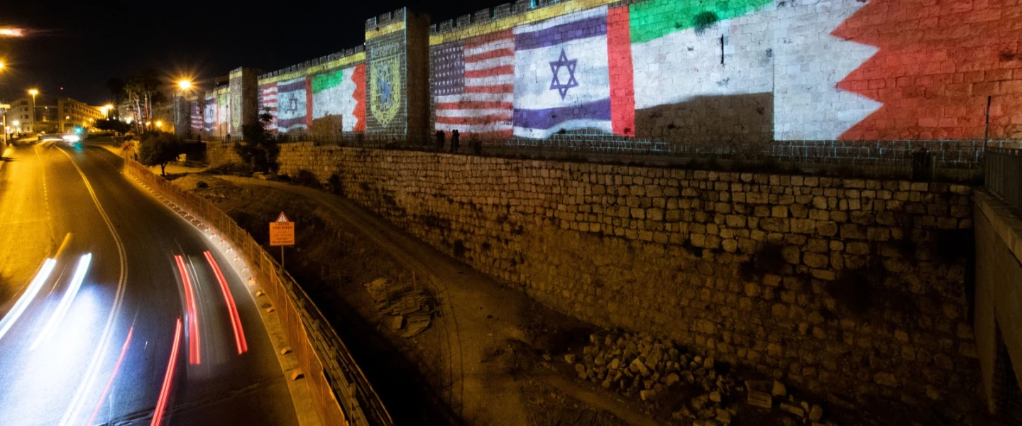 The flags of the U.S., the United Arab Emirates, Israel and Bahrain are screened on the walls of Jerusalem's Old City on Sept. 15, 2020. Photo: Yonatan Sindel/Flash90.