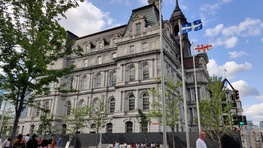 People walk by Montreal City Hall on July 14, 2019 in Montreal, Quebec. Photo by Daniel Slim/AFP via Getty Images.