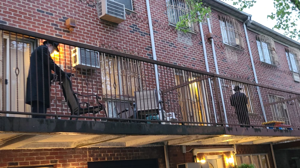 Jewish residents in the Crown Heights neighborhood of Brooklyn, N.Y., participate in a “porch minyan,” April 30, 2020. Photo by Dovid Zaklikowski.