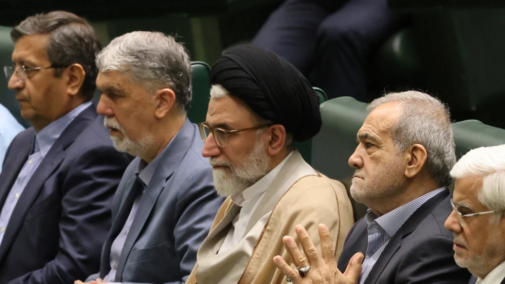 Iran's incumbent Intelligence Minister Esmail Khatib (C) sits with Iran's President Masoud Pezeshkian (C-R) before a speech to members of parliament in Tehran, Aug. 17, 2024, as he defends his cabinet selection. Photo by Atta Kenare/AFP via Getty Images.