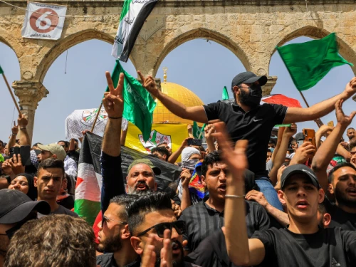 Palestinians wave Hamas flags outside the Al-Aqsa mosque on the Temple Mount in Jerusalem during the last Friday of Ramadan, April 29, 2022. Photo by Jamal Awad/Flash90.