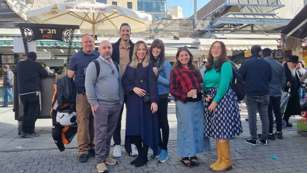 Jamie Geller and her production team at Aish stop for a moment to pose in the Mahane Yehuda Market, Dec. 8, 2025. Photo by Sharon Altshul.