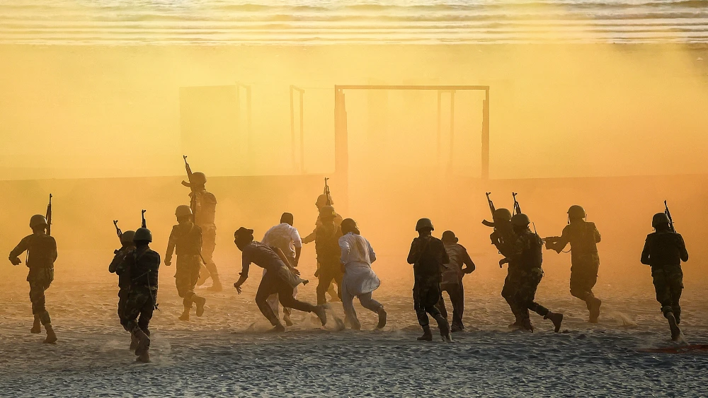 Pakistani Marines take part in a drill during the International Defense Exhibition and Seminar at the beach in Karachi on Nov. 17, 2022. Photo by Rizwan Tabassum/AFP.