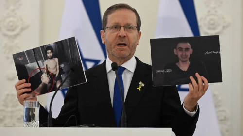 Israeli President Isaac Herzog holds pictures of hostages Evyatar David (left) and Rom Braslavski during a press conference in Vilnius, Lithuania, Aug. 4, 2025. Photo by Haim Zach/GPO.