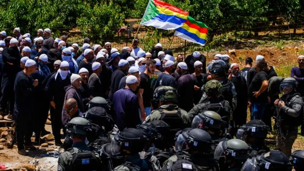 Druze protest while police guard during a protest against the construction of a new wind farm near the Druze village of Majdal Shams, in the Golan Heights, June 20, 2023. Photo by Ayal Margolin/Flash90 *** Local Caption *** ???? ???????? ????? ?????? ??????? ????? ???? ??