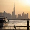 A man walks along Dubai's Creek Harbour, with the Burj Khalifa visible in the background, on April 3, 2026. Photo by Fadel Senna/AFP via Getty Images.