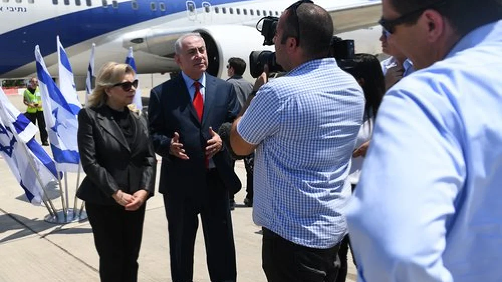 Israeli Prime Minister Benjamin Netanyahu, alongside his wife Sara, gives remarks before boarding a plane June 30, 2017. Credit: Kobi Gideon/GPO