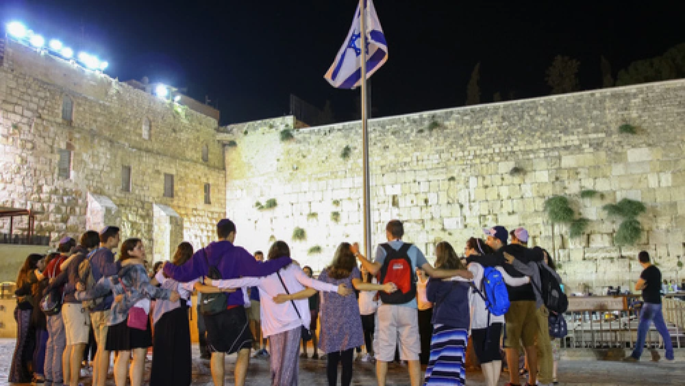 Participants of Ramah's Israel summer-camp experience stand arm in arm at the Western Wall in Jerusalem. Credit: Ramah Commission.