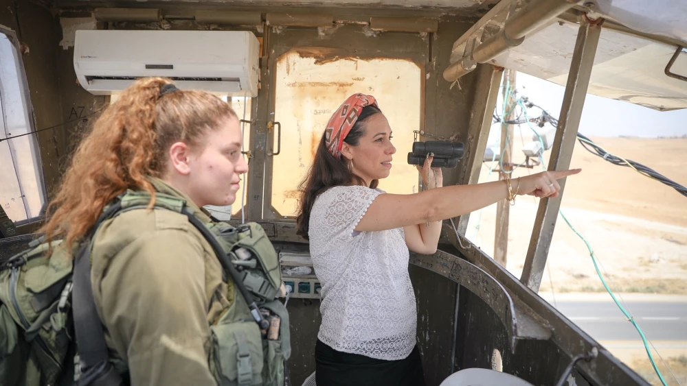 Yael Eckstein, head of the International Fellowship of Christians and Jews, at a lookout station with an Israeli soldier. As the new head of the International “Fellowship” that helps 1.5 million people a year, she has taken what her father, Rabbi Yechiel Eckstein, built and is adding her own vision to the 36-year-old organization. Credit: Courtesy.