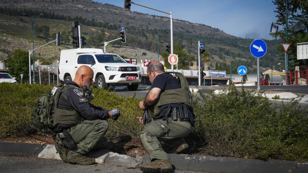 Israel Border Police officers look for fragments after a rocket from Lebanon hit Kiryat Shmona, Jan. 8, 2024. Photo by Ayal Margolin/Flash90.