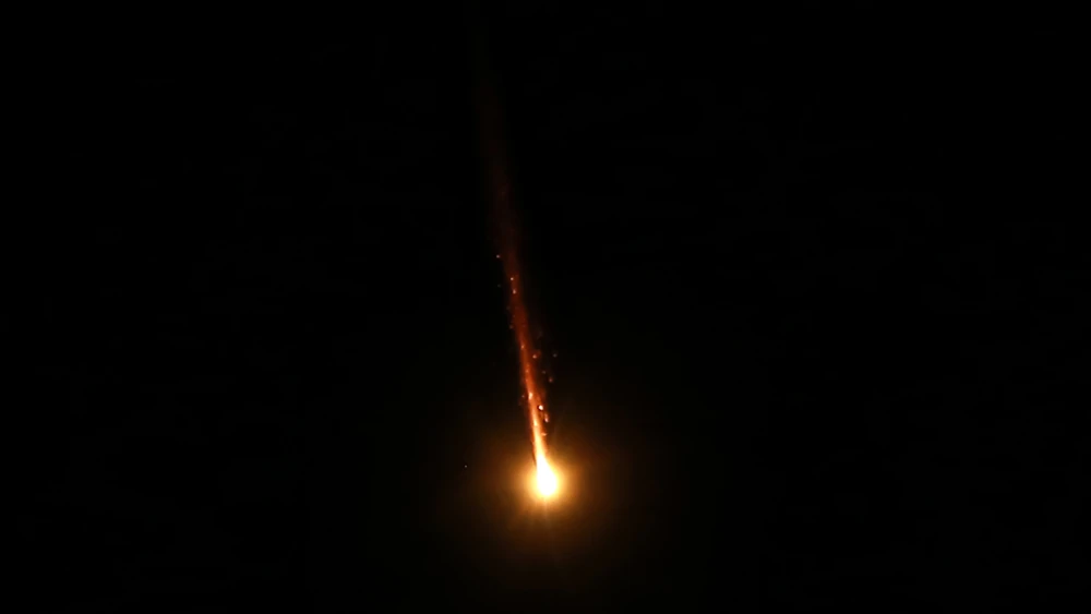 Missiles fired from Iran are pictured in the night sky over Amman in Jordanian airspace on June 14, 2025. Photo by Khalil Mazraawi/AFP via Getty Images.