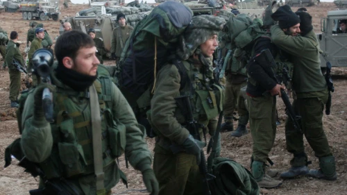 Israeli infantry reservists prepare to cross into the Gaza Strip, at a deployment area near the Israeli-Gaza border, Jan. 12, 2009. Credit: Roni Schutzer/Flash90.