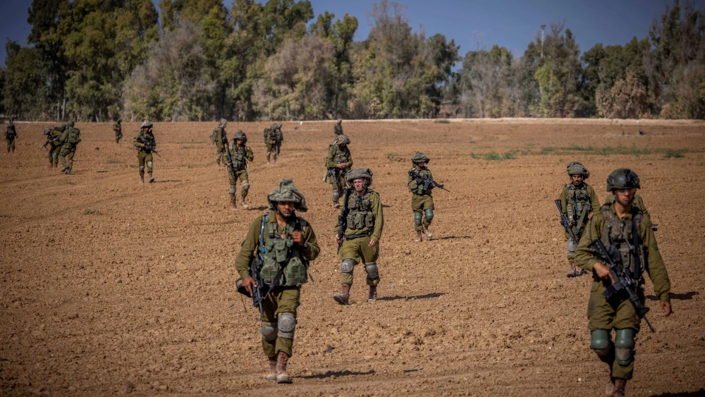 Israeli soldiers from the Netzach Yehuda Battalion patrol near the border with the Gaza Strip, Oct. 20, 2023. Photo by Yonatan Sindel/Flash90.