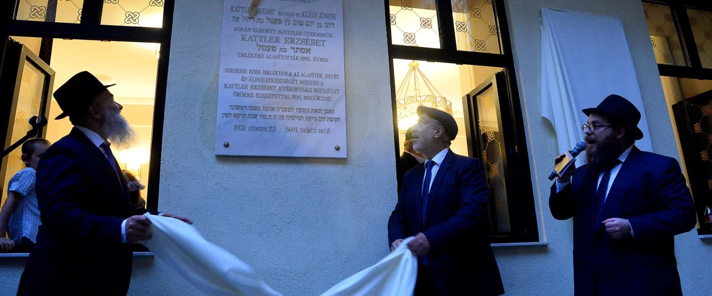 Community members unveil a plaque at the reopening of the Ohel Ezster synagogue in Budapest, Sept. 5, 2023. Photo by Zsolt Demecs.