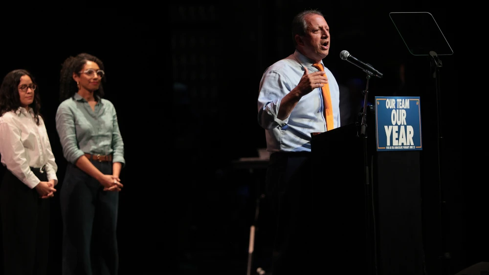 Congressional candidate Brad Lander, standing with Claire Valdez and Darializa Avila Chevalier, speaks during a Get Out the Vote rally at Kings Theater in New York City, June 18, 2026. Credit: Michael M. Santiago/Getty Images.