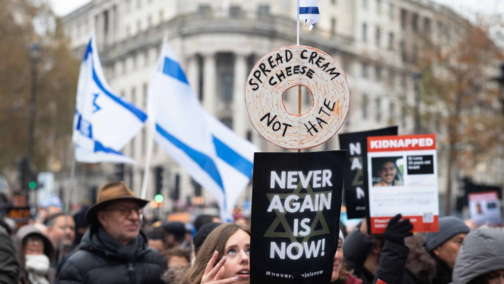 Israel supporters at the “March Against Antisemitism” in London hold flags and placards in support of hostages taken by Hamas to Gaza, Nov. 26, 2023. Photo by Andy Soloman/Shutterstock.
