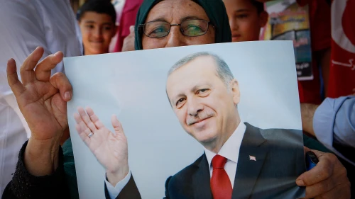 Palestinians holds pictures of the Turkish President Recep Tayyip Erdoğan as they wear shirts with Turkish flags in the West Bank city of Hebron on July 20, 2016. Photo by Wisam Hashlamoun/Flash90.