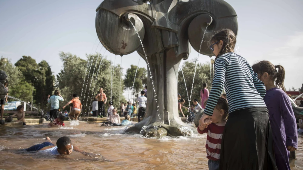 Israeli children play in a water fountain in Jerusalem on a hot day, May 25, 2015. Photo by Hadas Parush/Flash90.
