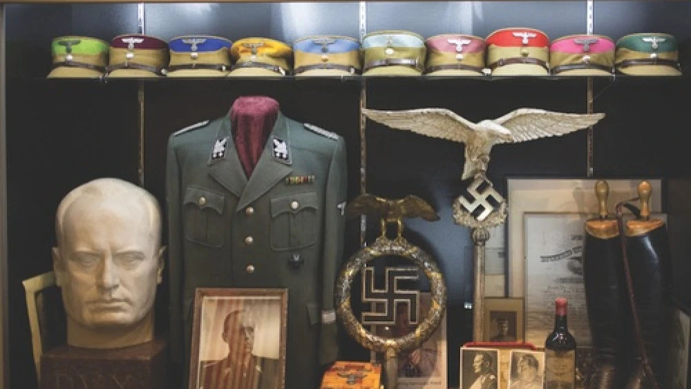 Inside the Solana Beach, Calif., warehouse of Craig Gottlieb. Lining the walls of the warehouse are Nazi military uniforms, iron crosses, swastika flags, and German military propaganda. Credit: Daisy Varley.