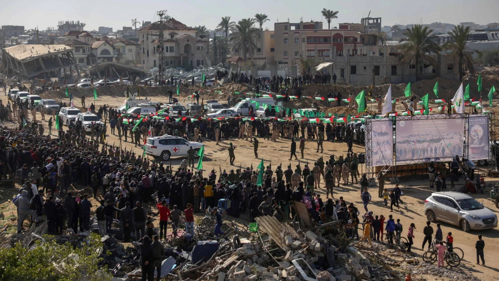 Red Cross vehicles wait at the spot where Hamas terrorists are expected to hand over Israeli hostages in Khan Yunis in the southern Gaza Strip, Feb. 15, 2025. Photo by Bashar Taleb/AFP via Getty Images.