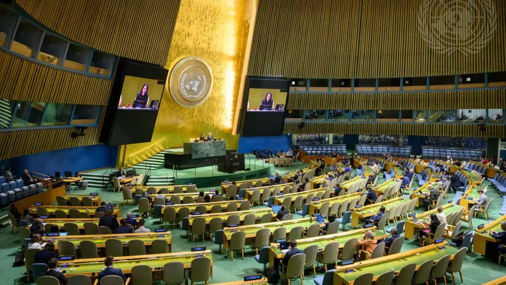 Annalena Baerbock (on screen), president of the 80th session of the U.N. General Assembly, chairs the General Assembly's 79th plenary meeting, addressing Russia and China's veto of a draft resolution to protect shipping in the Strait of Hormuz, April 16, 2026. Credit: Loey Felipe/UN Photo.