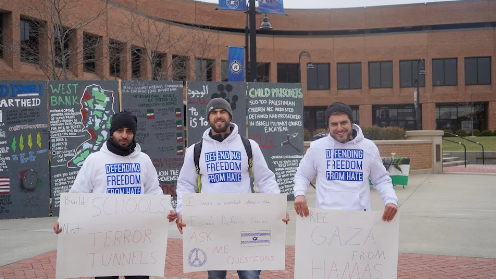 Members of Reservists on Duty holding pro-Israel signs in front of an “Apartheid Wall” at Kent State University. Credit: Reservists on Duty.