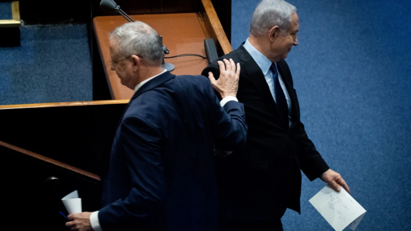 Blue and White Party leader Benny Gantz passes Israeli Prime Minister Benjamin Netanyahu at a memorial ceremony in the Knesset marking 24 years since the assassination of former Israeli Prime Minister Yitzhak Rabin, on Nov. 10, 2019. Photo by Yonatan Sindel/Flash90.