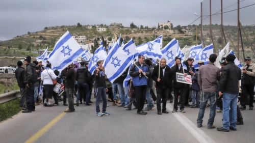 Hundreds march with Israeli flags and signs reading "bringing back deterrence" from the Jewish settlement of Karmei Tzur to the Gush Etzion Junction in the settlement bloc in the West Bank, on March 15, 2016. Photo by Gershon Elinson/Flash90.