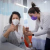 A staff member receives a second dose of Pfizer's BioNTech COVID-19 vaccine at the Sheba Medical Center at Tel HaShomer on Jan. 10, 2021. Photo by Miriam Alster/Flash90.