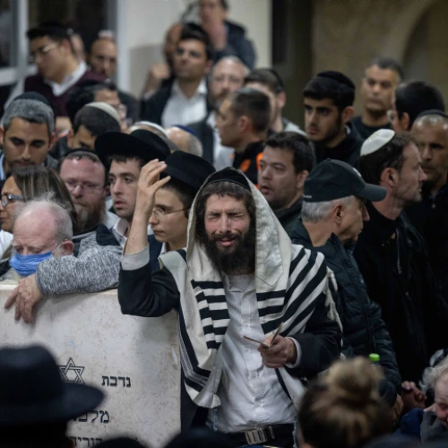 Mourners attend the funeral at the Beit Shemesh Cemetery for Eli and Natalie Mizrahi, who were murdered in the shooting attack in Jerusalem's Neve Ya'akov neighborhood on Friday, Jan. 28, 2023. Photo by Yonatan Sindel/Flash90.