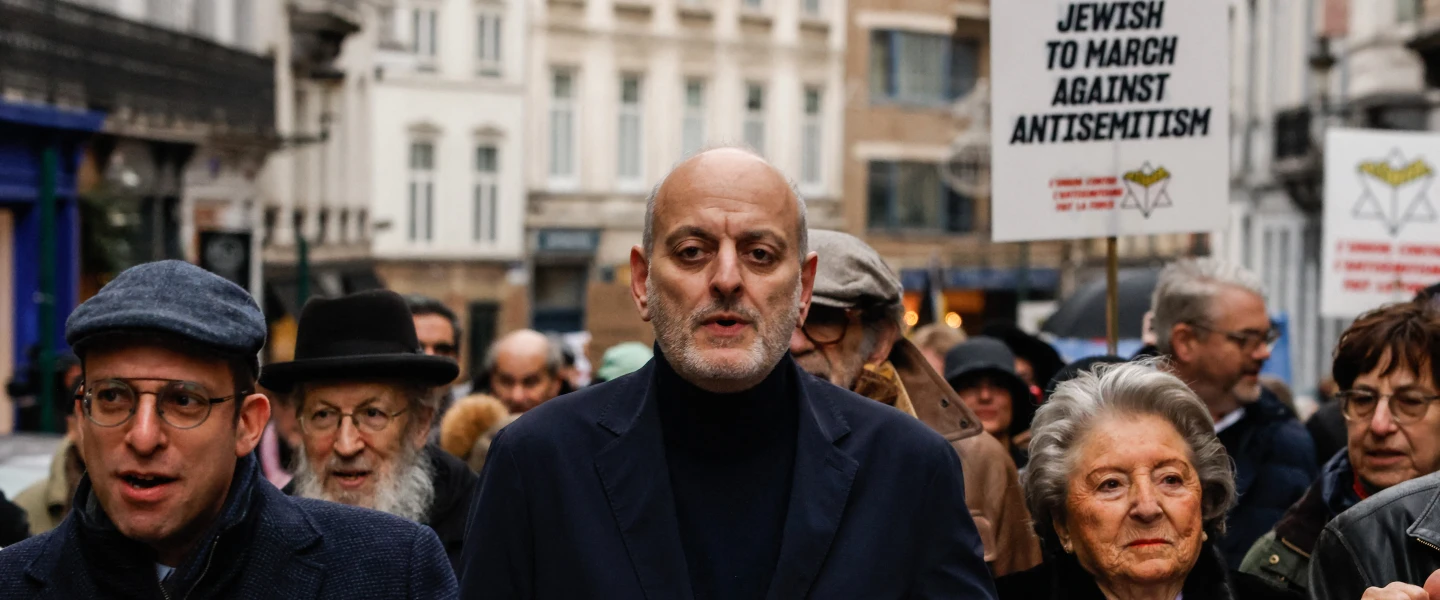 Joël Rubinfeld, president of the Belgian League Against Antisemitism, center, and Regine Sluszny, president of the Forum of Jewish Organizations of Belgium’s Flemish Region, carry a banner as they take part in a march against Antisemitism in Brussels, Belgium on Dec. 10, 2023. Photo by SIMON WOHLFAHRT/AFP via Getty Images.