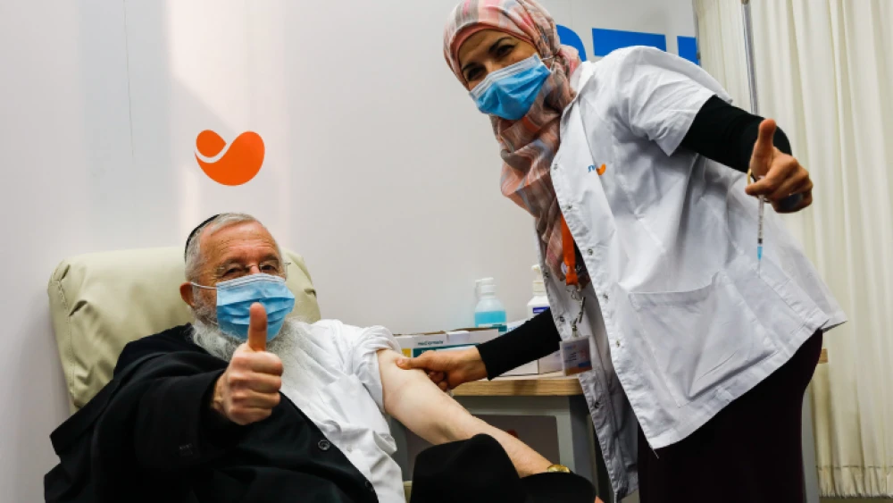 An Israeli receives a COVID-19 vaccine in Jerusalem on Dec. 21, 2020. Photo by Olivier Fitoussi/Flash90.
