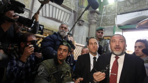 Israeli Defense Minister Avigdor Lieberman is seen surrounded by security as he visits the Tomb of the Patriarchs and Matriarchs in the city of Hebron on Jan. 14, 2013. Photo by Flash90.