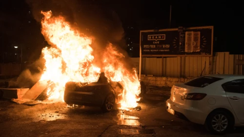 A car is set on fire during clashes between Arab and Jews in Acre, northern Israel, May 12, 2021. Credit: Roni Ofer/Flash90