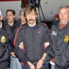 Viktor Bout, a Russian arms dealer known as the “Merchant of Death,” escorted by U.S. federal agents, Nov. 16, 2010. Credit: DEA.
