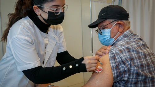 An Israeli over the age of 60 receives a fourth dose of the COVID-19 vaccine at a medical center in Ashkelon. Jan. 3, 2022. Photo by Flash90.