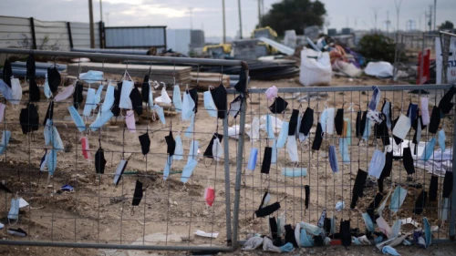 Protective face masks hang on a fence in Glilot, Feb. 14, 2022. Photo by Tomer Neuberg/Flash90.