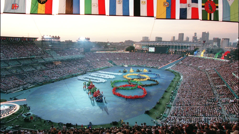 A general view of the Olympic Stadium as performers form the Olympic rings and a 100 number during the opening ceremony of the Centennial Olympic Games in Atlanta, 19 July 1996. Photo by Pascal Guyot/AFP via Getty Images.