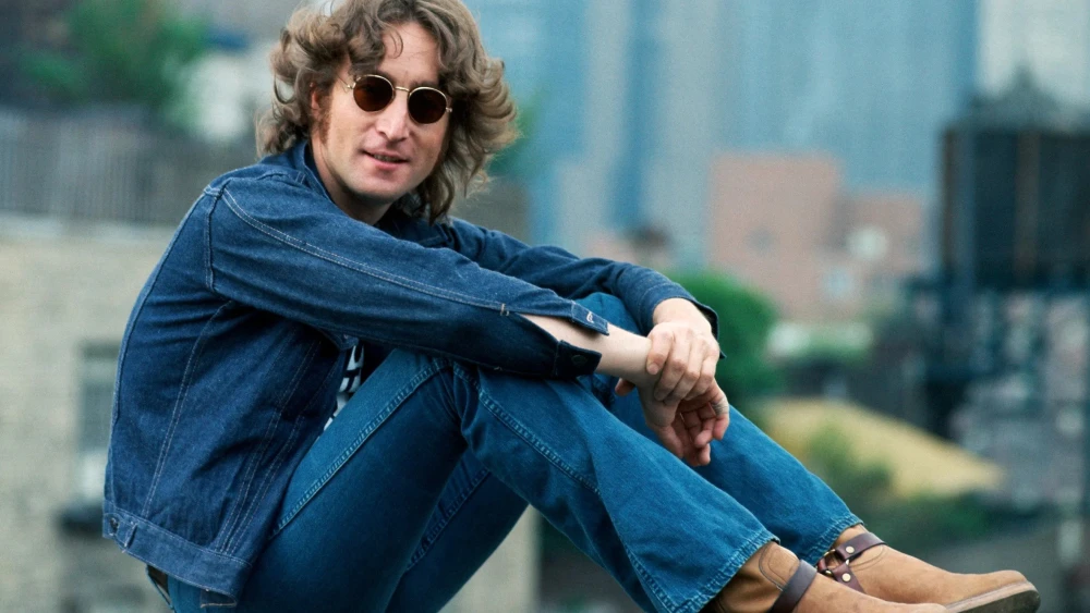 A press photo of John Lennon to promote his “Walls and Bridges” album, 1974. Credit: Bob Gruen/Distributed by Capitol Records via Wikimedia Commons.