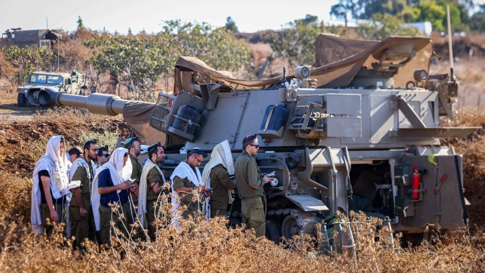 Israeli soldiers pray next to their artillery units near the Israeli border with Lebanon, northern Israel, Sept. 29, 2024. Photo by David Cohen/Flash90.