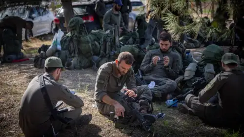 Israeli soldiers take a break before entering the Gaza Strip, Dec. 20, 2023. Photo by Yonatan Sindel/Flash90.