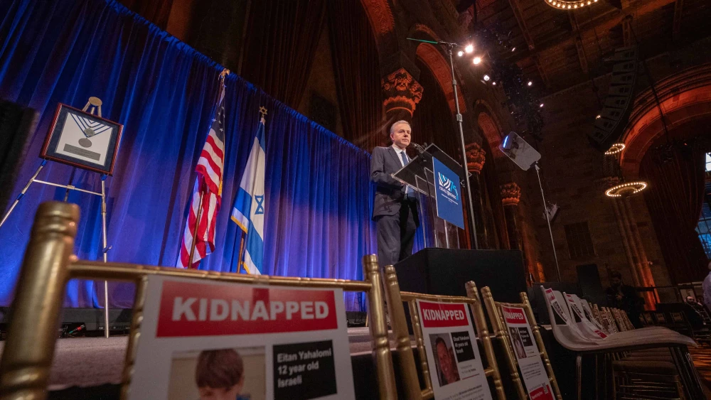 On November 13, 2023, Israel Bonds President & CEO Dani Naveh addresses guests at the organization’s Real Estate & Allied Division Luncheon in New York City, surrounded by empty seats in honor of the hostages abducted by Hamas. Photo by Shahar Azran.