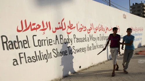 Palestinians hold pictures of Rachel Corrie in the southern Gaza Strip on July 28 at the end of a local football match named the "Rachel Corrie Cup", in honor of the U.S. activist who was run over by an Israeli bulldozer at a pro-Palestinian demonstration in 2003. Photo by Abed Rahim Khatib/Flash90.