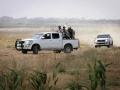 Palestinian terrorists of the Ezzedine al-Qassam Brigades, Hamas' armed wing, sit in the back of a pick-up truck watching Israeli bulldozers working along a barbed wire fence that separates Khan Yunis in the southern Gaza Strip and the Israeli border, on June 10, 2015. Photo by Abed Rahim Khatib/Flash 90.