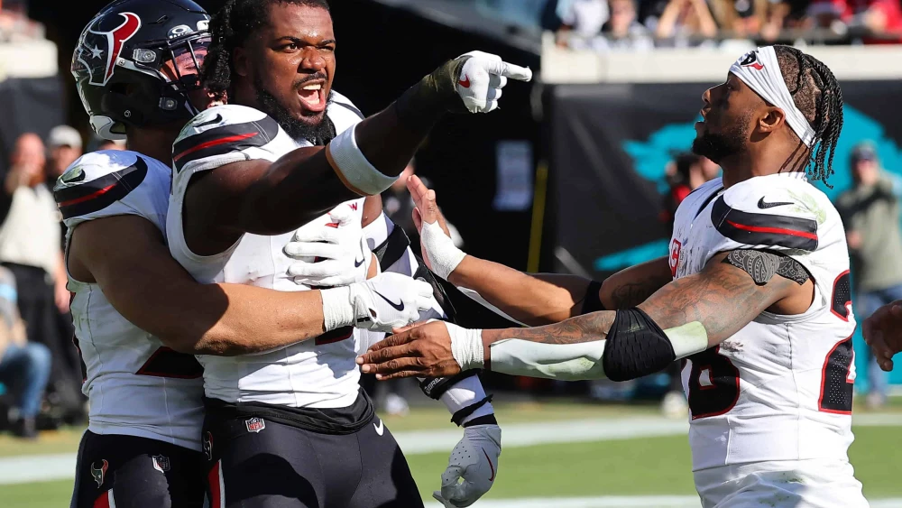 Azeez Al-Shaair, No. 0 of the Houston Texans, points to the Jacksonville Jaguars bench after a fight and being ejected during the second quarter of a game at EverBank Stadium in Jacksonville, Fla., on Dec. 1, 2024. Photo by Mike Carlson/Getty Images.